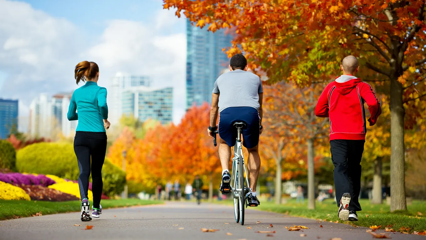 People walking through a vibrant urban park with trees and pathways in a modern city setting